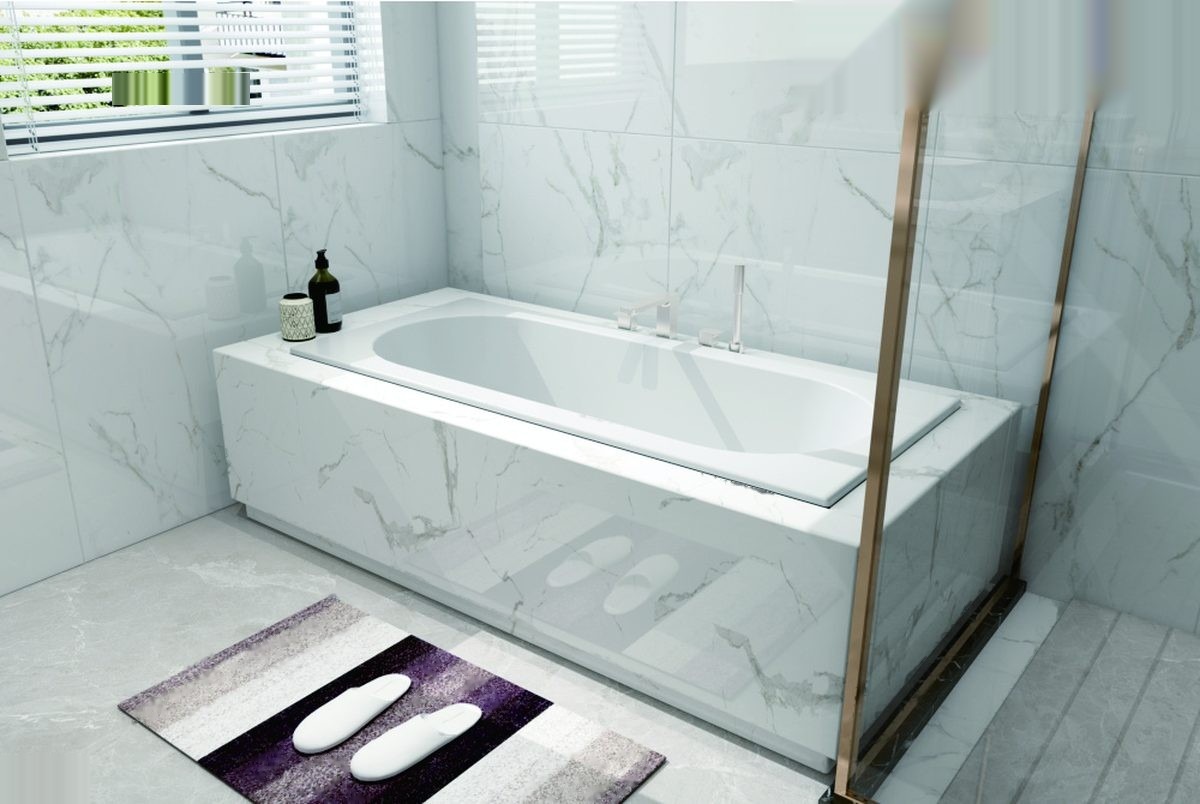 White rectangular inset acrylic bathtub with overflow, installed in a tiled bathroom